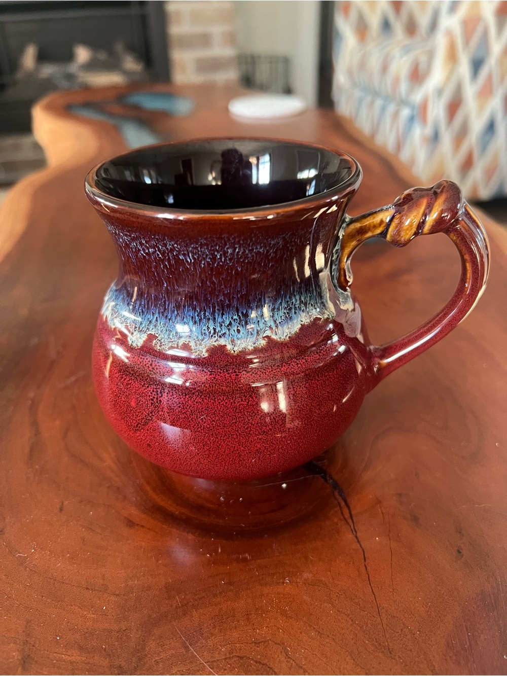 Glazed Red Ceramic Mug with Blue-Drip Accent and Twisted Handle